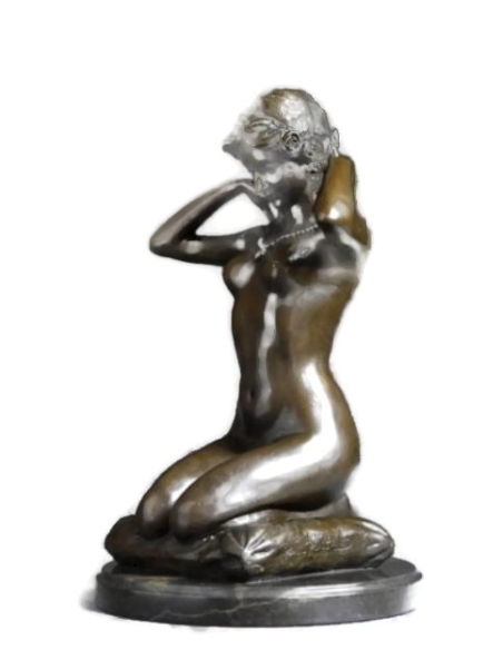 Woman kneeling on a cushion and adjusting her necklace - Paul Ponsard