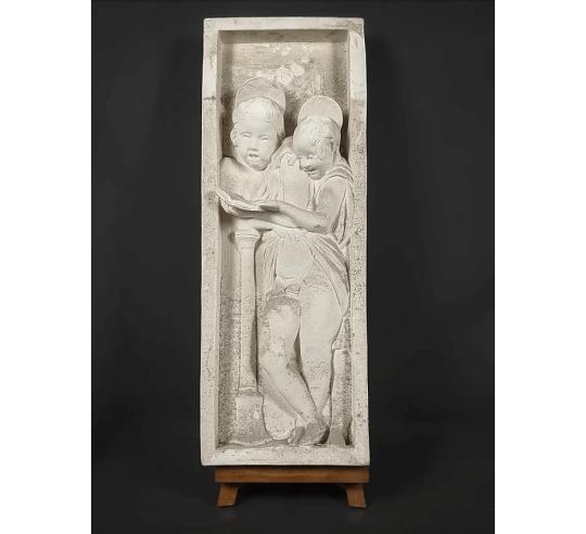 Bas relief of angels singing Bible verses
