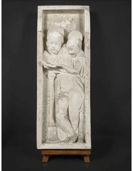 Bas relief of angels singing Bible verses