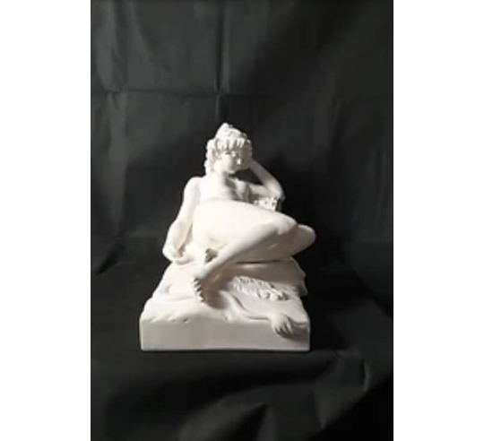 Statue of a nude woman lying on a lion skin by...