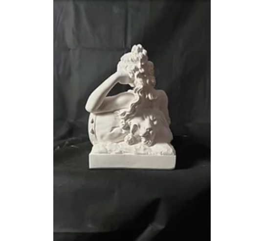 Statue of a nude woman lying on a lion skin by...