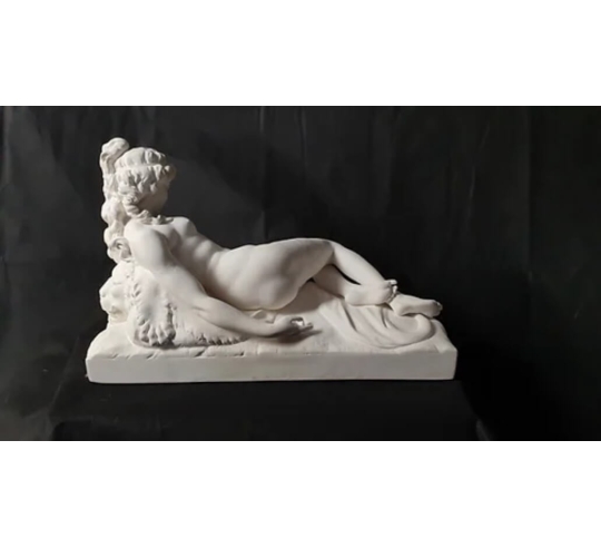 Statue of a nude woman lying on a lion skin by...