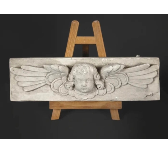 Low relief of an angel's head in Renaissance style