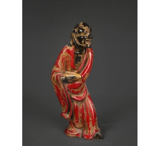 Statuette of a beggar with his begging bowl,...