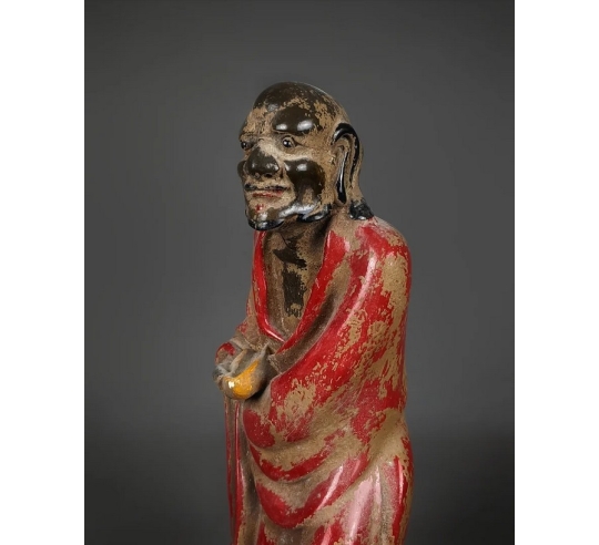 Statuette of a beggar with his begging bowl,...