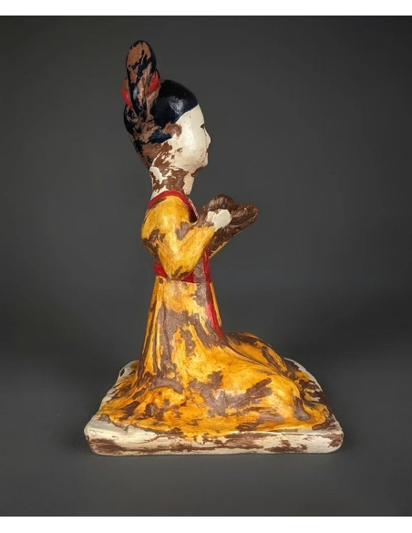 Statuette of a seated female musician playing cymbals, Tang dynasty style Chinese art.