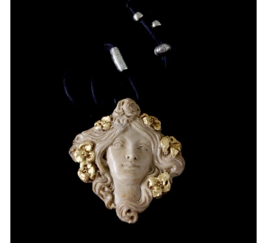 Medallion face of Muse with flowers in the hair.