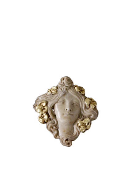 Medallion face of Muse with flowers in the hair.