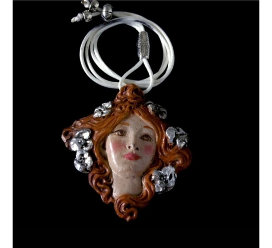 Medallion face of Muse with flowers in the hair.