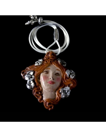 Medallion face of Muse with flowers in the hair.