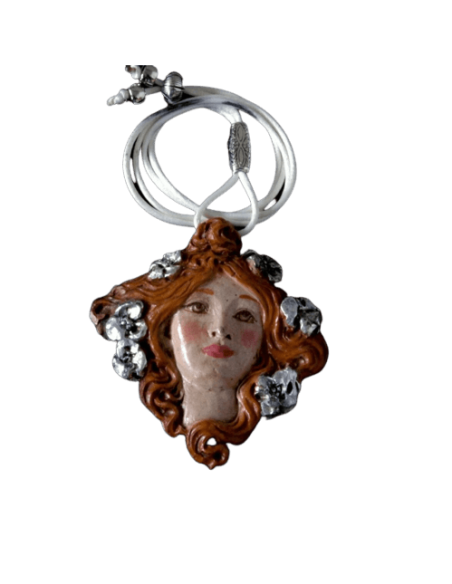 Medallion face of Muse with flowers in the hair.