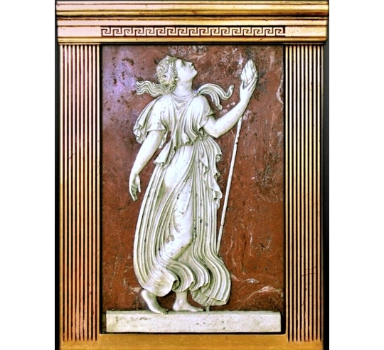 Low relief Maenad holding a Thyrsus, attribute of Dionysus.
